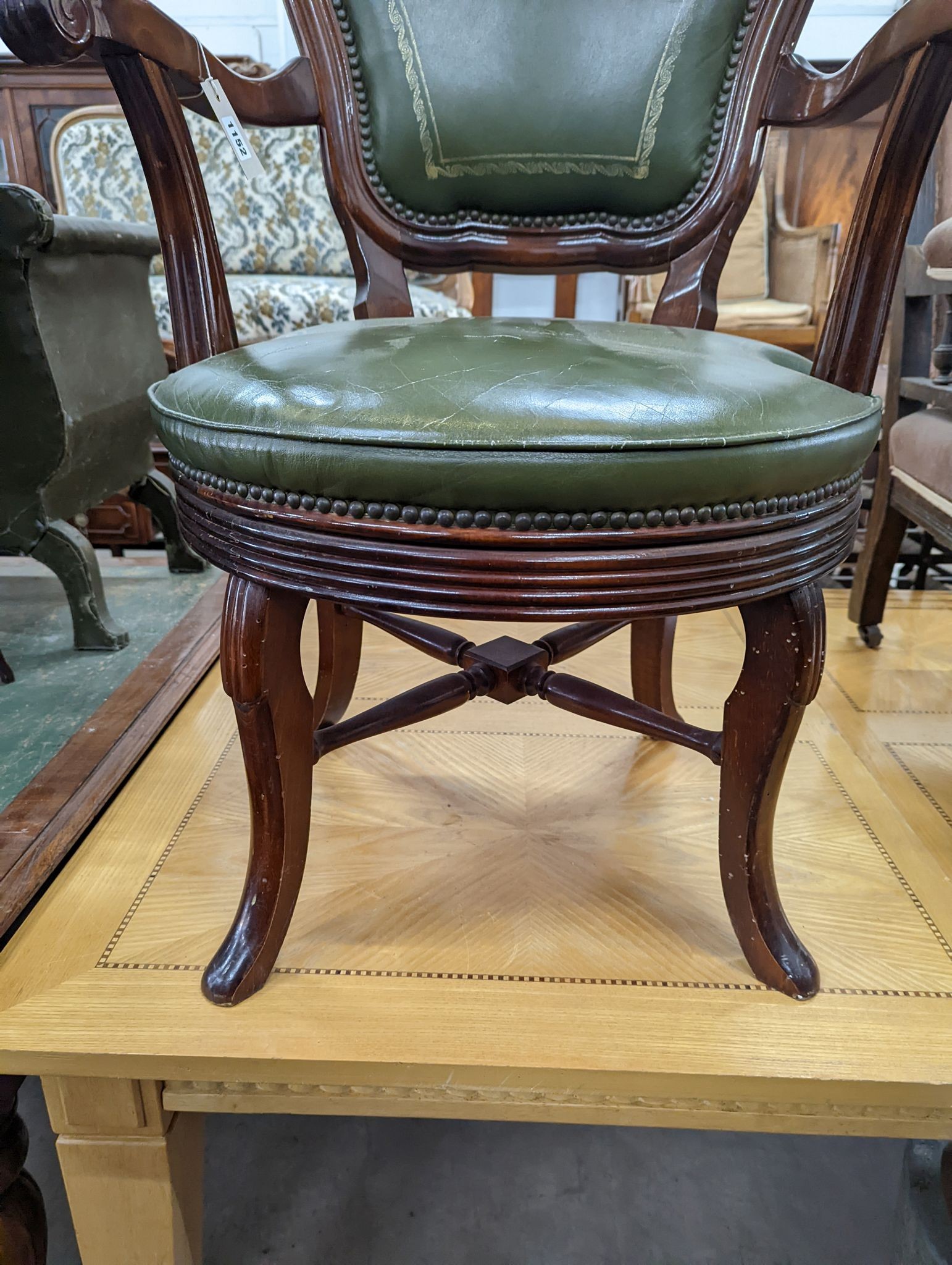 A Victorian style mahogany and green leather swivel desk chair, width 60cm, depth 50cm, height 96cm